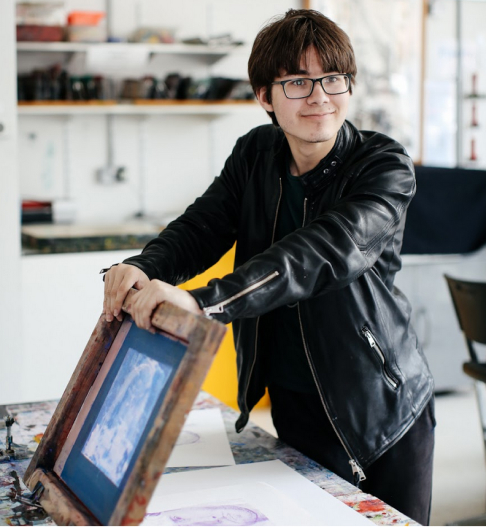 Student holding painting