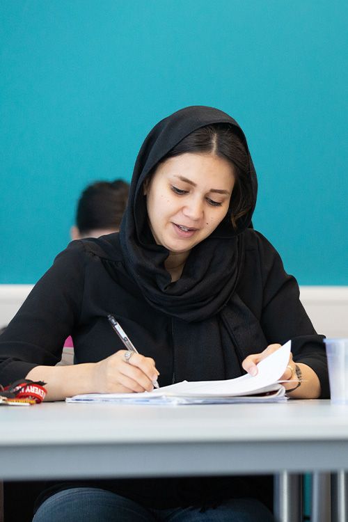 person writing in a notepad