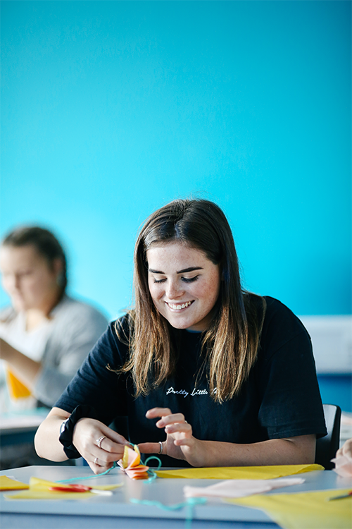 student painting a picture