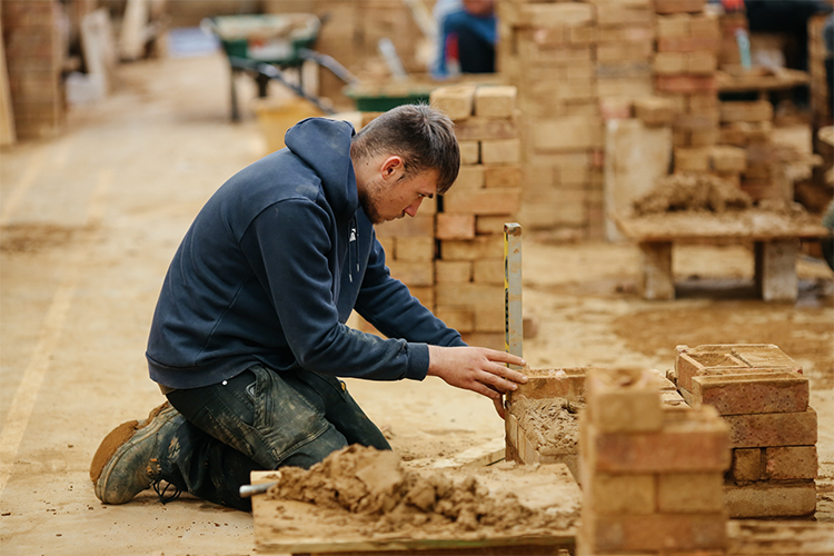 Student laying bricks