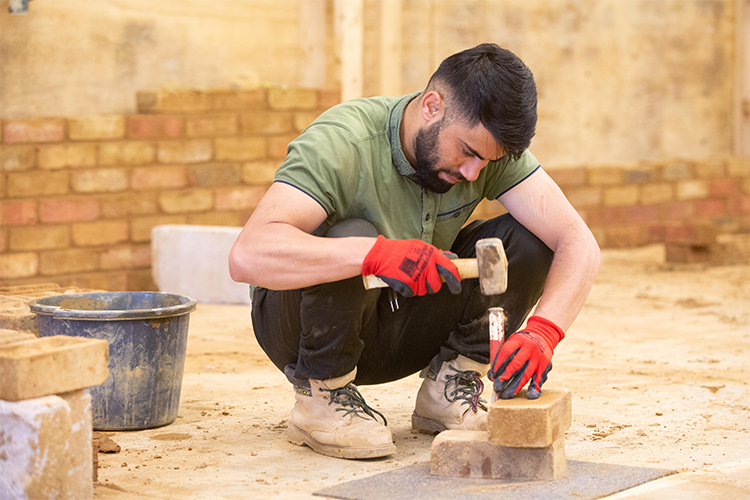 Student laying bricks