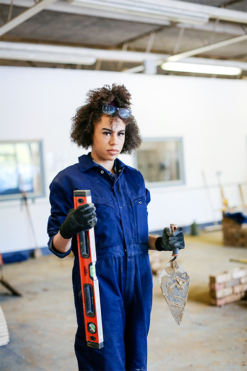 Student with brickwork tools