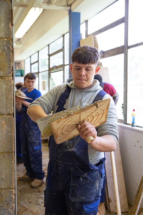 Student using plastering tools