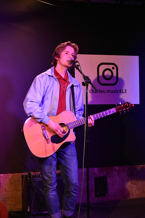 student playing guitar and singing