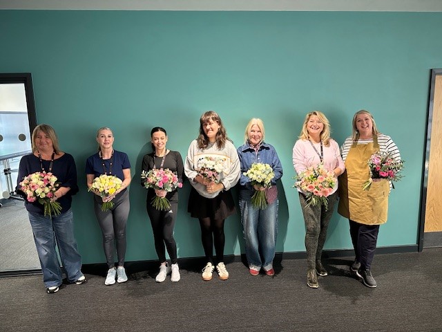 Group picture of people holding flowers