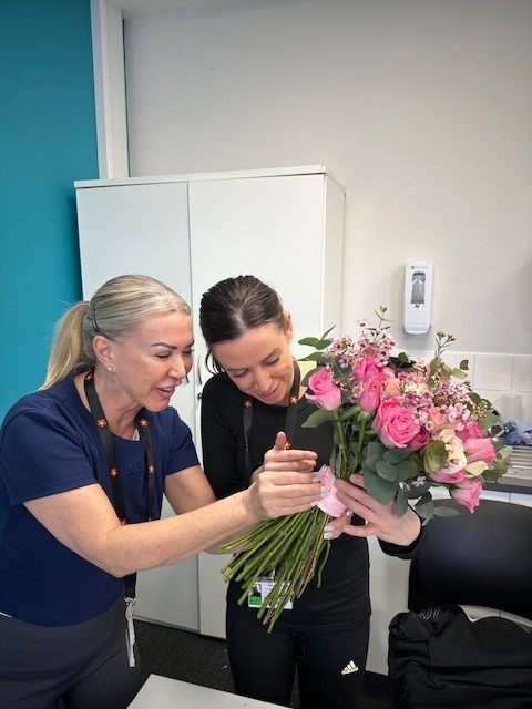 Student and tutor holding flowers