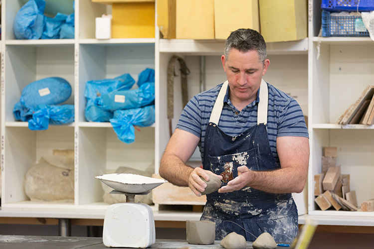 student creating a pottery project