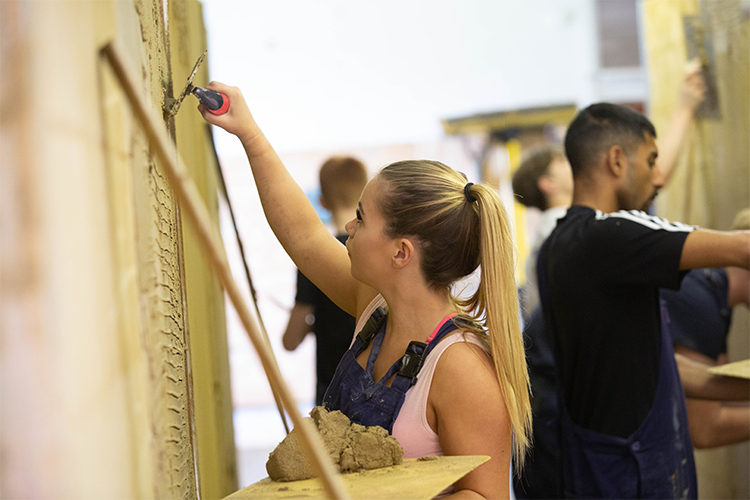 Student working on a plastering project