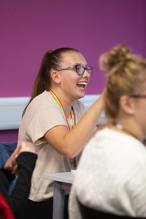 Student talking in a classroom
