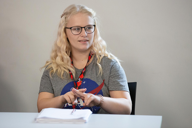 Student demonstrating sign language