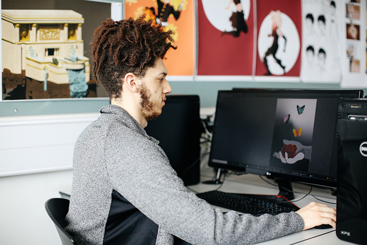 Boy designing a digital illustration on a computer