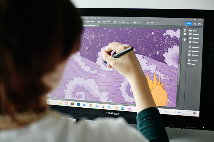 Student drawing a digital illustration on a tablet