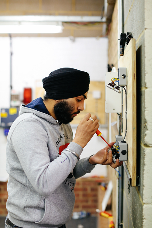 Student inspecting wiring