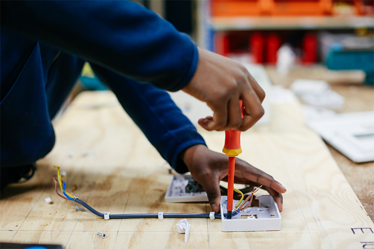 Student fixing some wiring