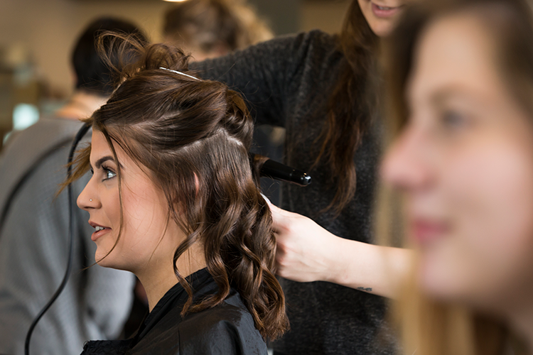 Student styling someone's hair