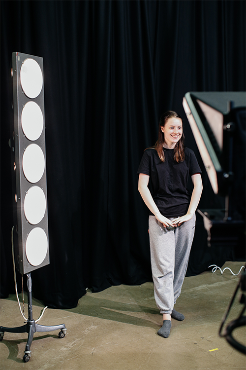 Student surrounded by lights and cameras