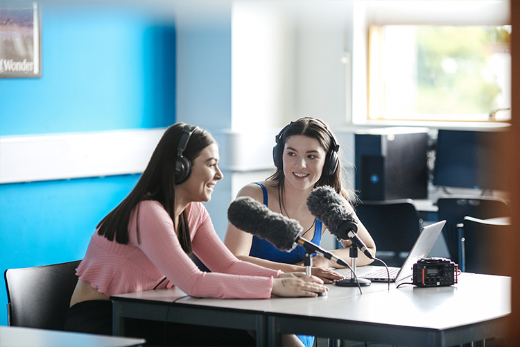 Students speaking into microphones