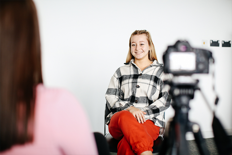 Student interviewing and filming another student