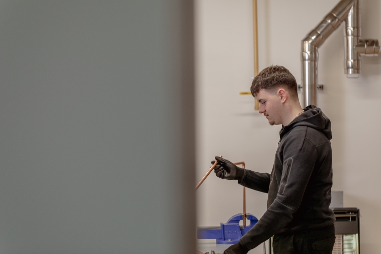 Student working on a plumbing project