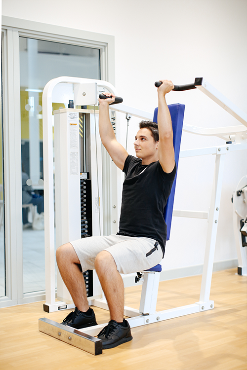 Student on weight machine