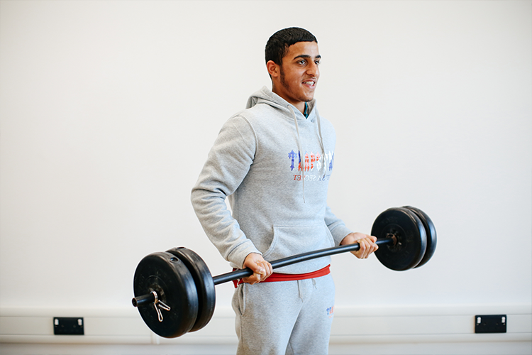 Student lifting a barbell