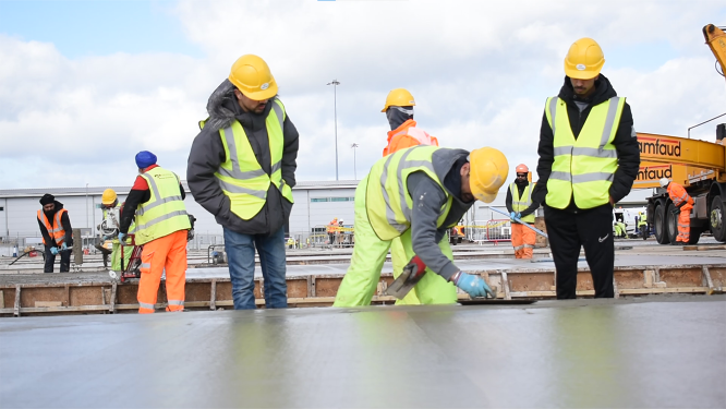 Two students watching a Ryebridge worker