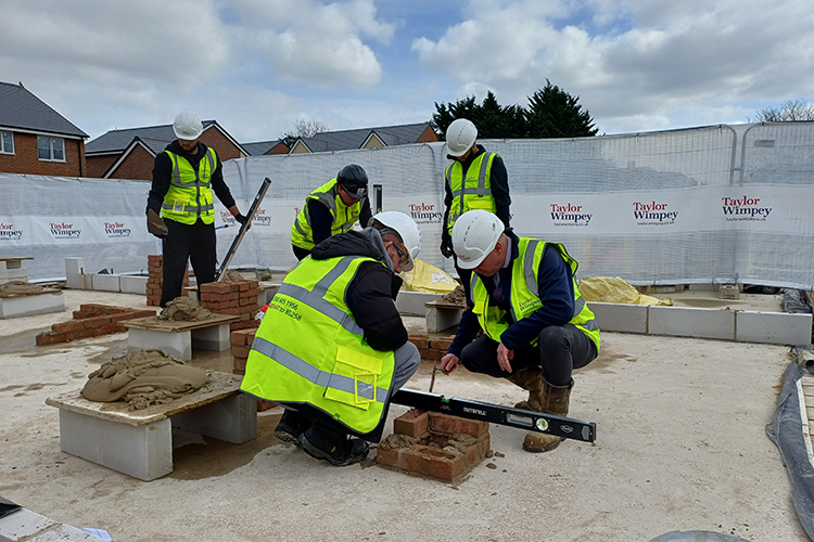 Students working on a Taylor Wimpey construction site