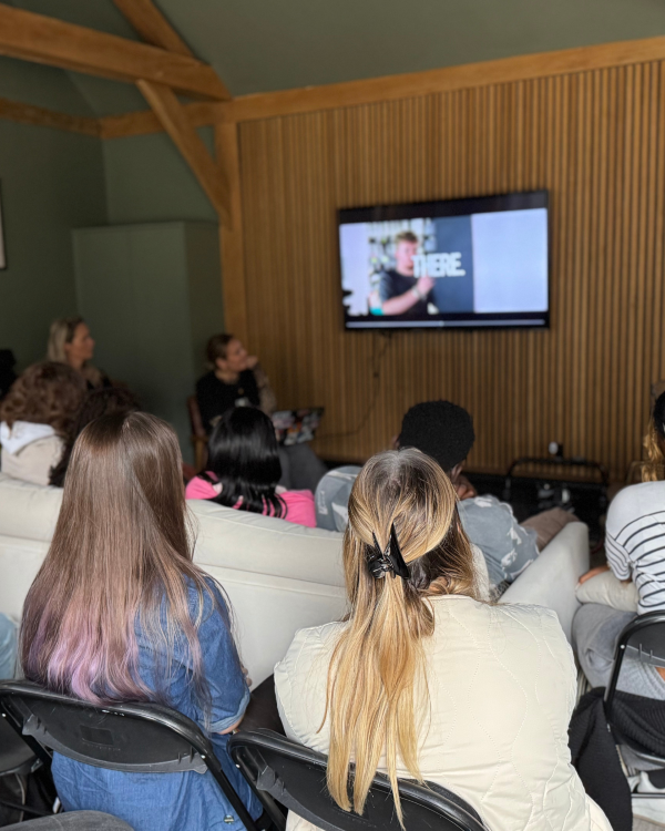 Students watching a video on a TV