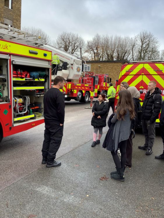 students gathered around a fire engine