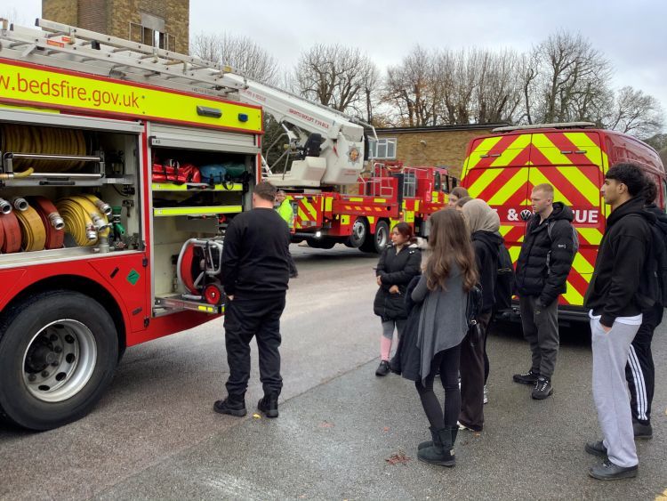students gathered round a fire engine